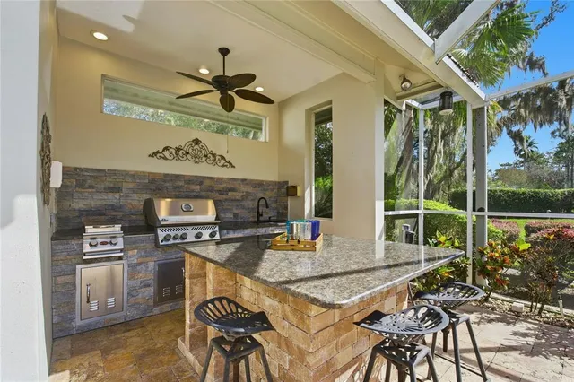 an aerial view of residential houses with outdoor space and lake view