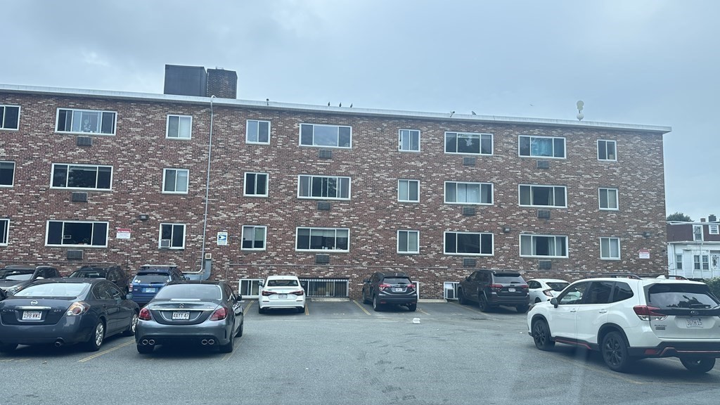 20 Radcliffe Road, Unit 54 Boston, MA 02134 - Photo 2 of 5 a car parked in front of a brick building