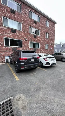 a car parked in front of a brick building
