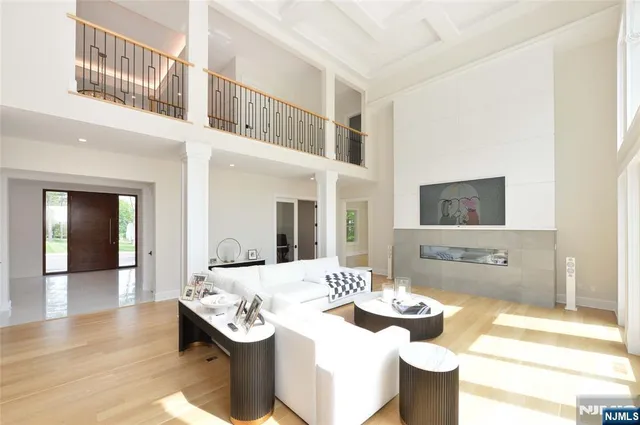 a living room with stainless steel appliances kitchen island granite countertop a sink and a granite counter tops
