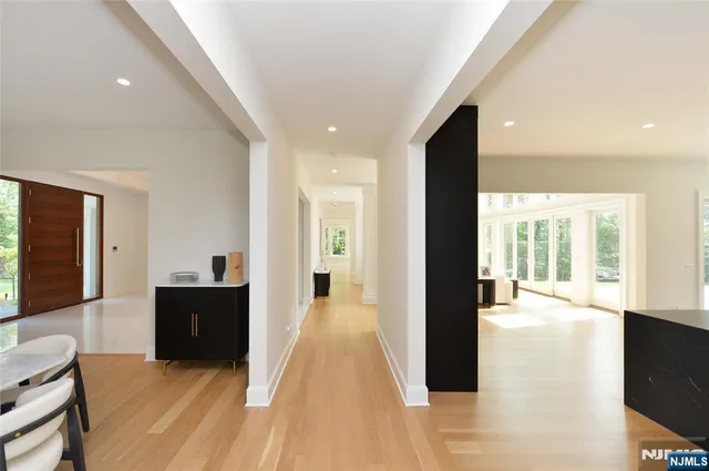 a view of a living room with wooden floor and furniture
