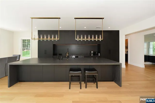 a kitchen with a wooden floor and cabinets