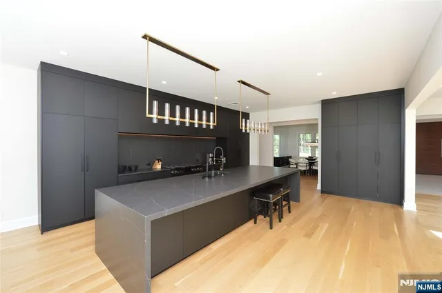 a kitchen with a sink a stove and a refrigerator