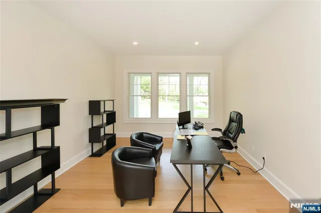 a view of a workspace with furniture and a window