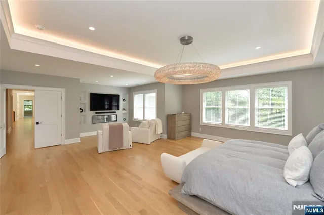 a spacious bedroom with a bed and a television