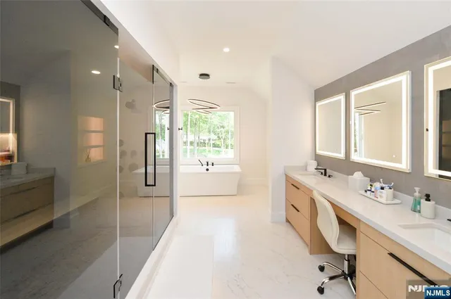 a bathroom with a double vanity sink a toilet a mirror and