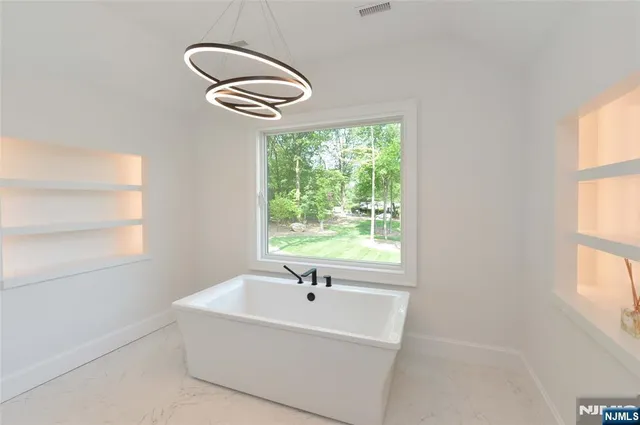 a white bath tub sitting next to a window