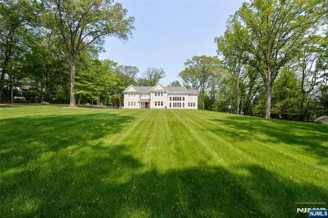 an aerial view of a house with pool yard and outdoor seating