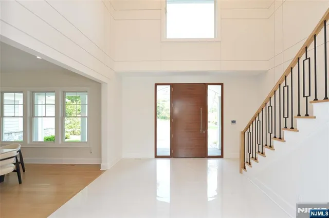 a view of an entryway with wooden floor and windows