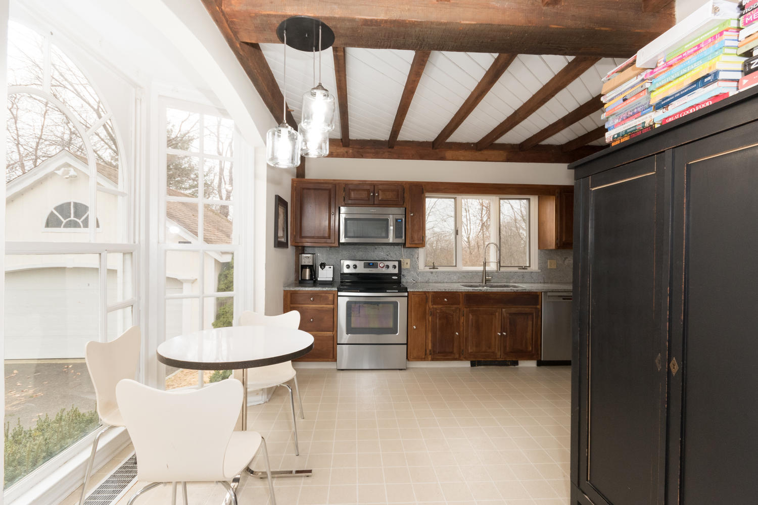 108 Long Neck Point Road Darien, CT 06820 - Photo 12 of 39 a kitchen with stainless steel appliances kitchen island granite countertop a table chairs and a refrigerator