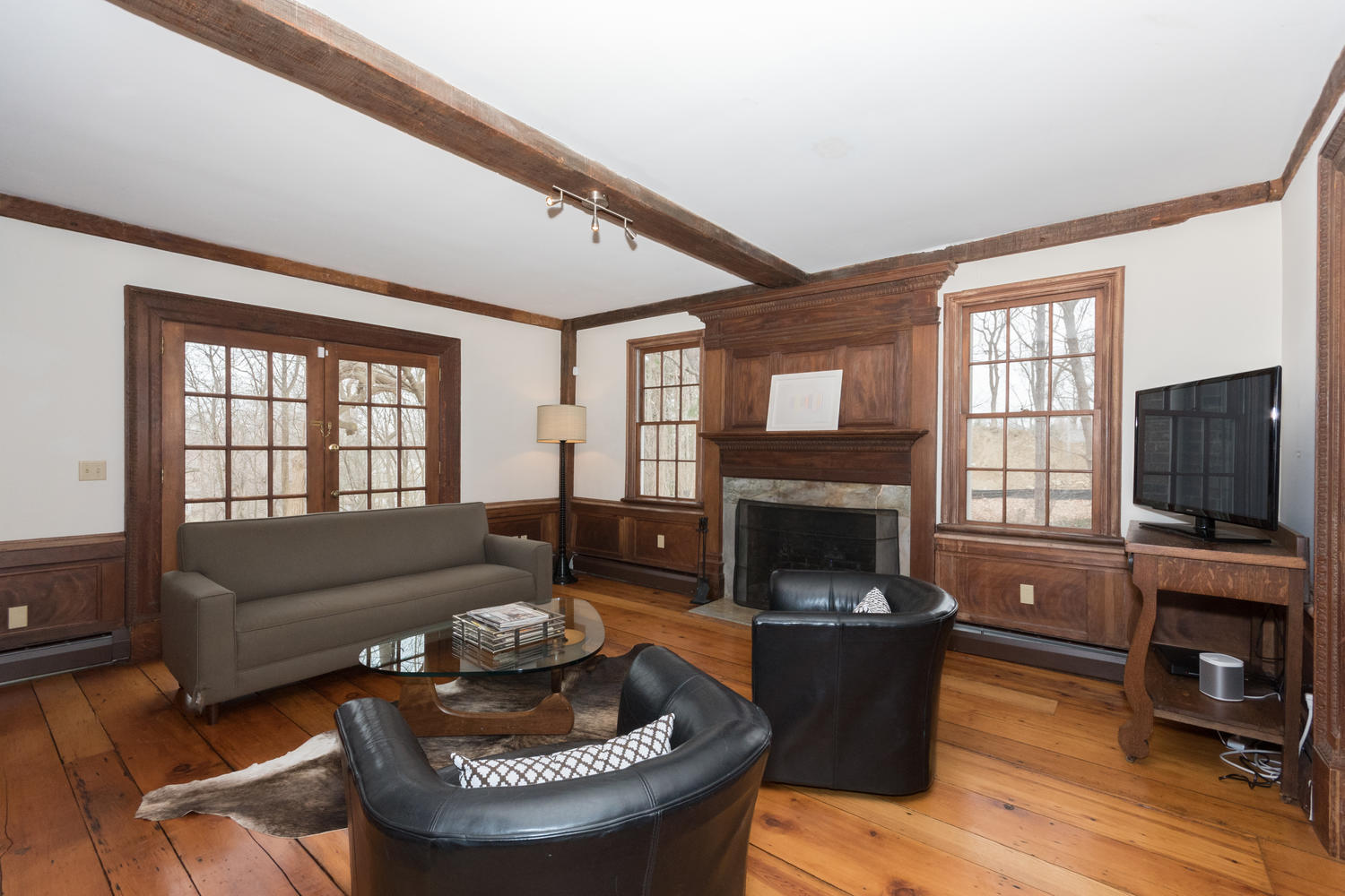 108 Long Neck Point Road Darien, CT 06820 - Photo 15 of 39 a living room with furniture a fireplace and a flat screen tv