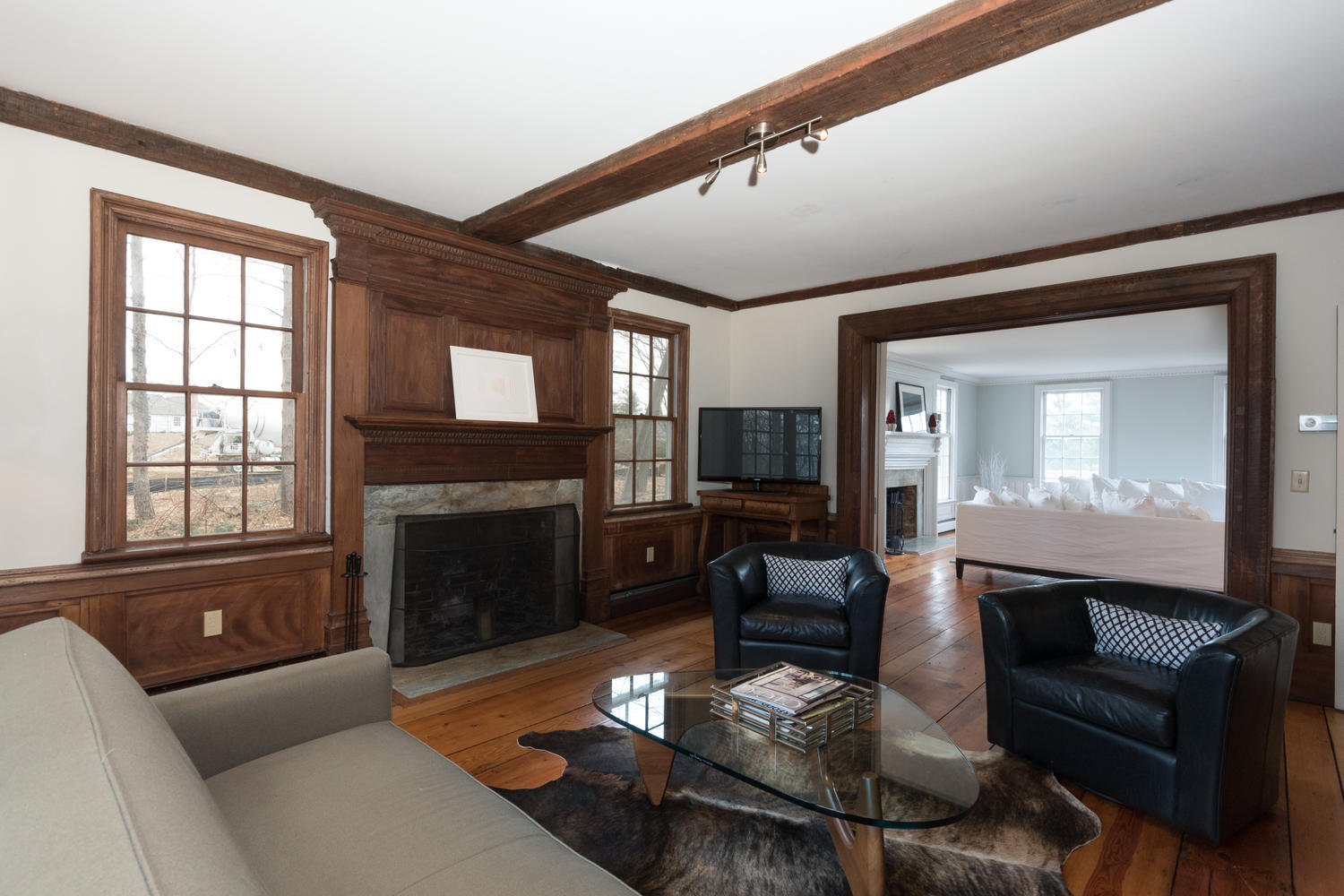 108 Long Neck Point Road Darien, CT 06820 - Photo 17 of 39 a living room with furniture a fireplace and a flat screen tv