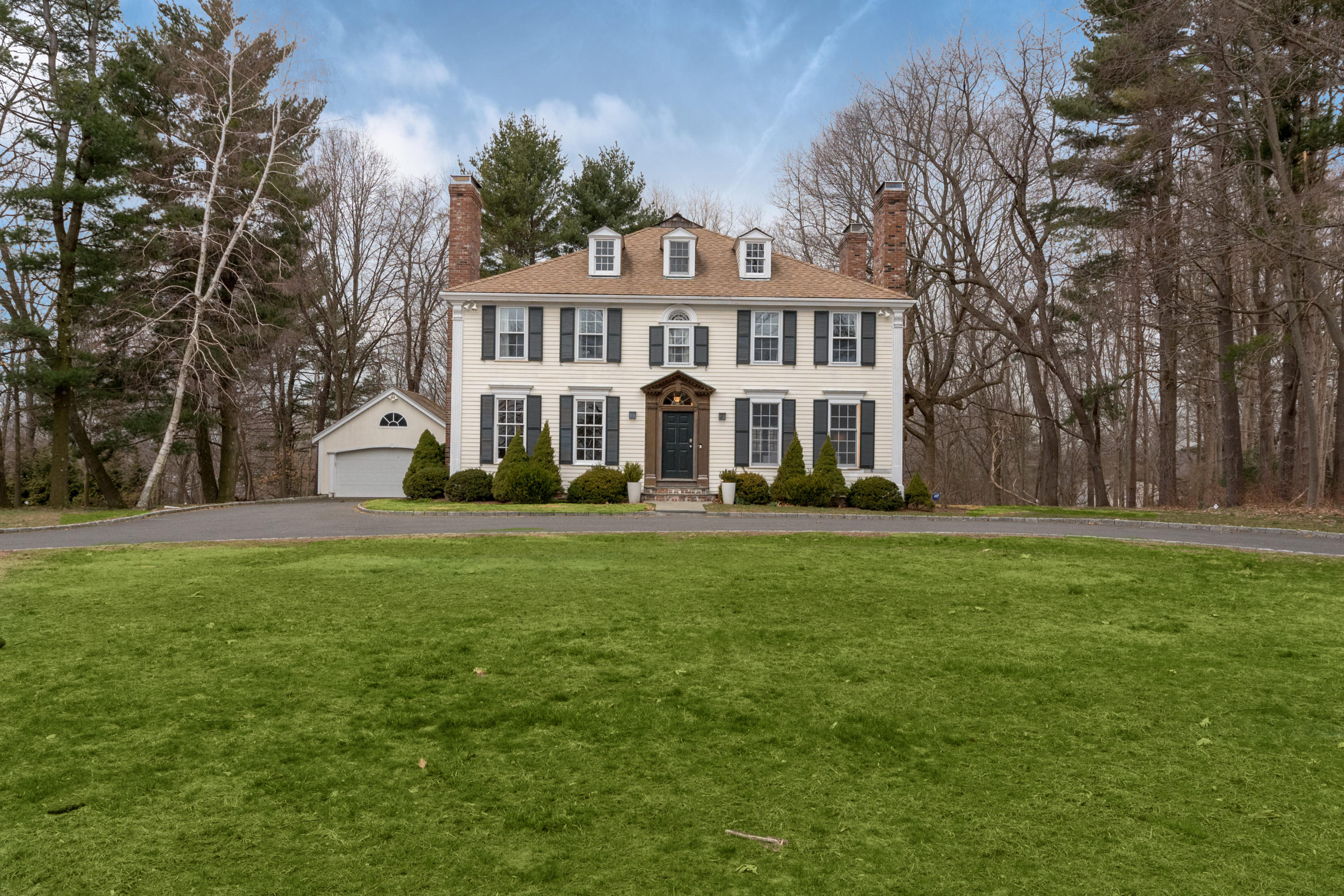 108 Long Neck Point Road Darien, CT 06820 - Photo 2 of 39 a front view of a house with a garden