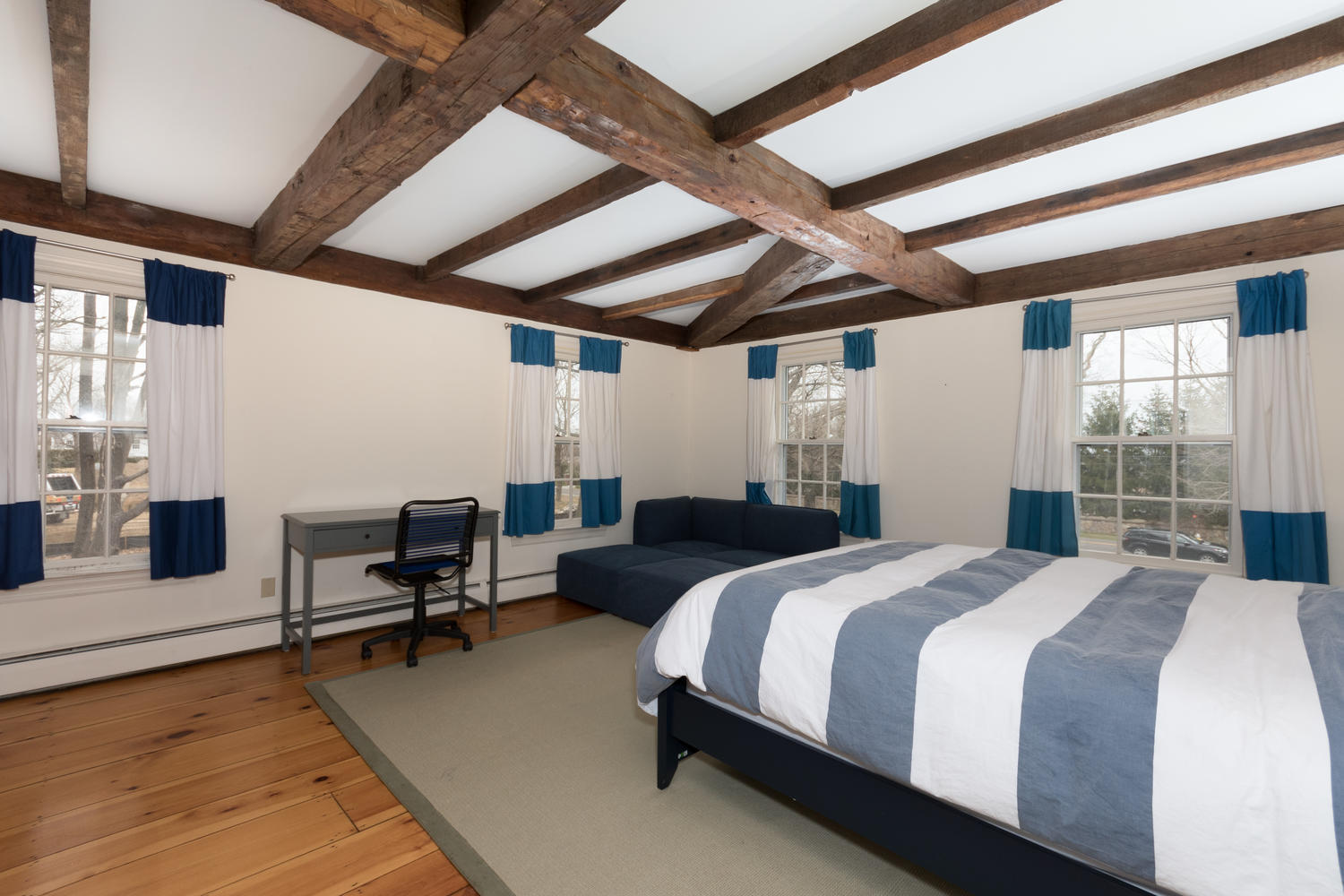 108 Long Neck Point Road Darien, CT 06820 - Photo 24 of 39 a bedroom with a bed wooden floor and furniture
