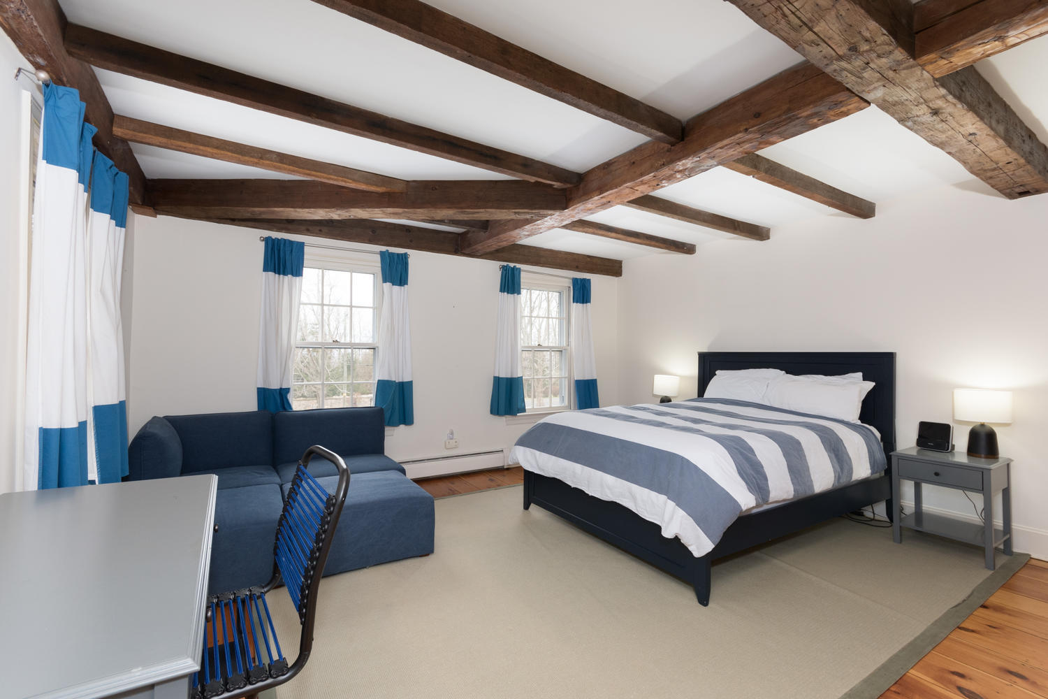 108 Long Neck Point Road Darien, CT 06820 - Photo 25 of 39 a spacious bedroom with a bed and a couch