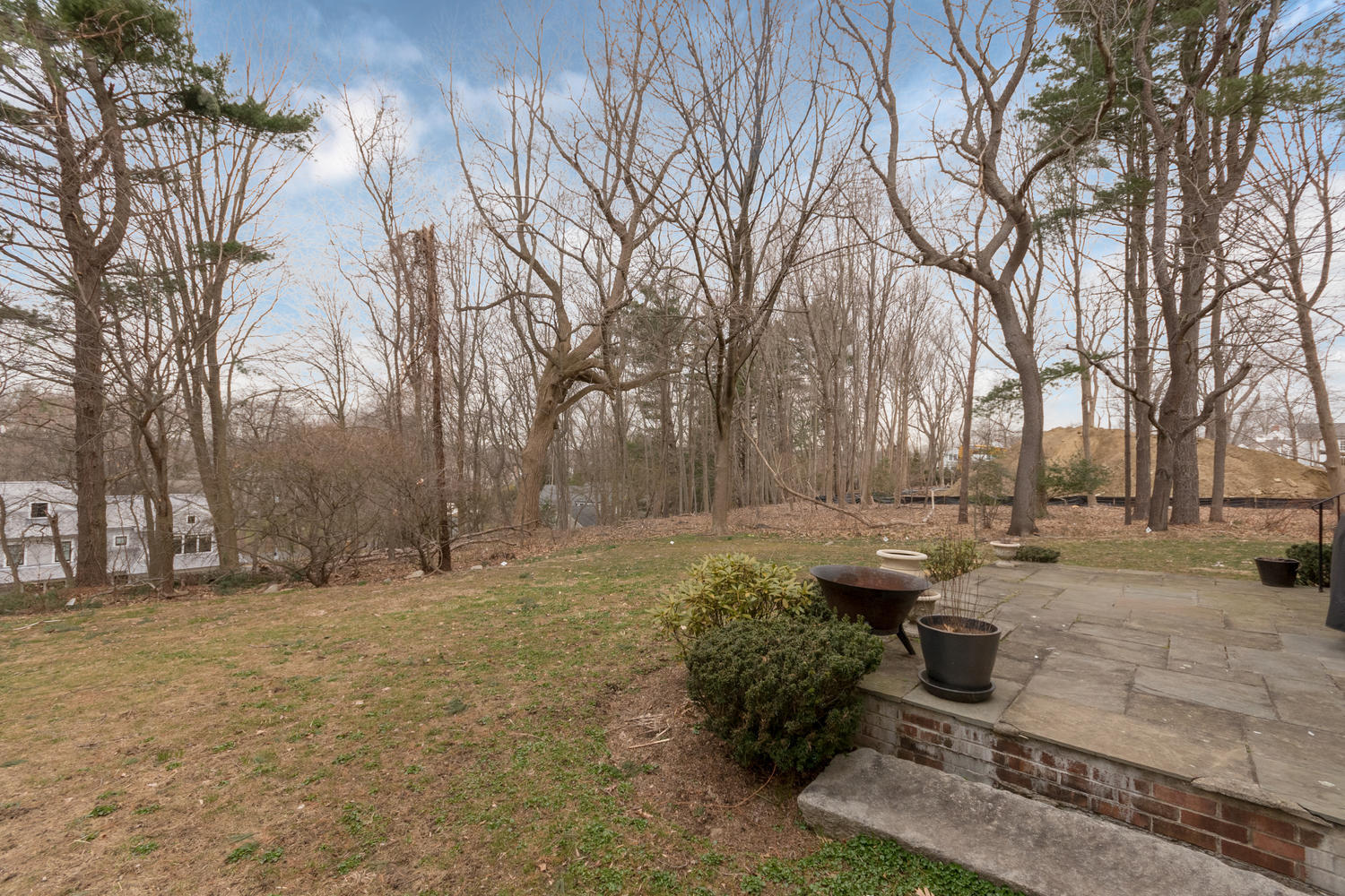 108 Long Neck Point Road Darien, CT 06820 - Photo 35 of 39 a backyard of a house with barbeque oven and outdoor seating