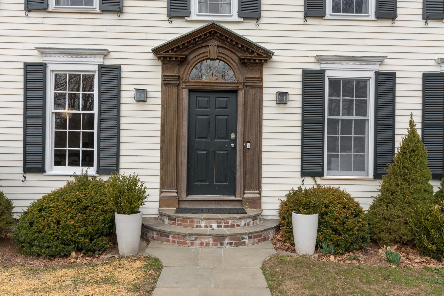 108 Long Neck Point Road Darien, CT 06820 - Photo 4 of 39 a view of a brick house with potted plants
