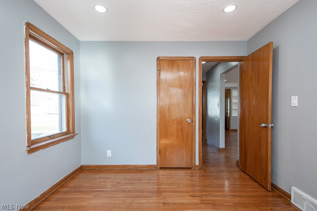 2231 Lorimer Road Cleveland, OH 44134 - Photo 17 of 28 Empty room featuring plenty of natural light and light wood-type flooring