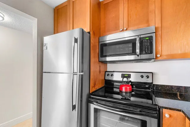 a kitchen with a refrigerator and stove
