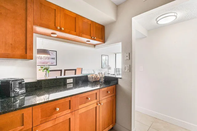 a kitchen with granite countertop a sink and cabinets