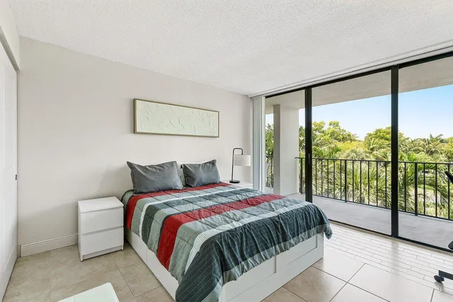 a bedroom with a large bed and a large window