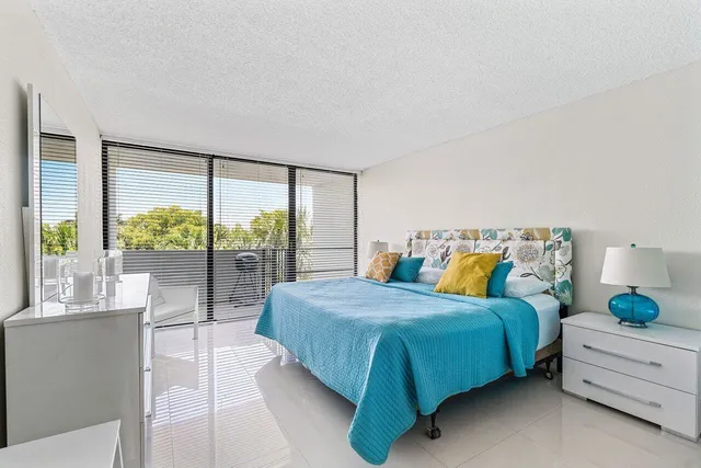 a bedroom with a bed and a large window