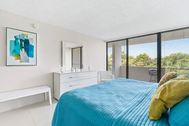 a bedroom with a large bed and a large window