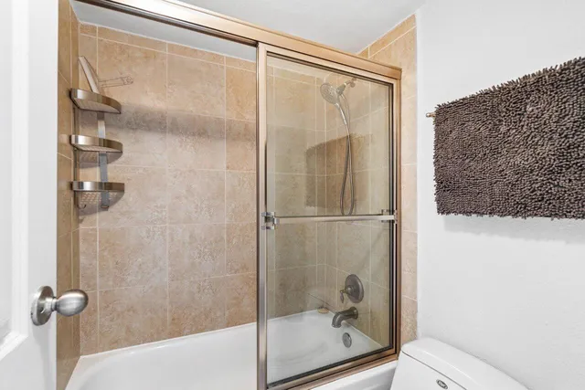 a bathroom with a glass shower door