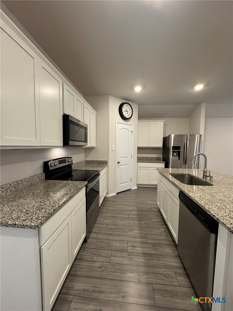 208 Ida Loop Seguin, TX 78155 - Photo 3 of 16 a large kitchen with granite countertop a large counter top appliances and cabinets