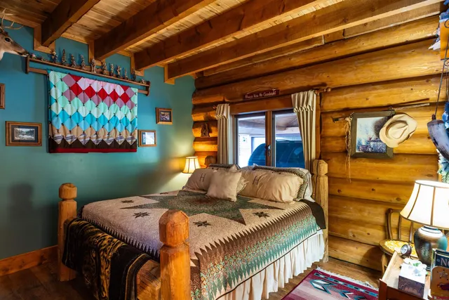 a bedroom with bed and wooden floor