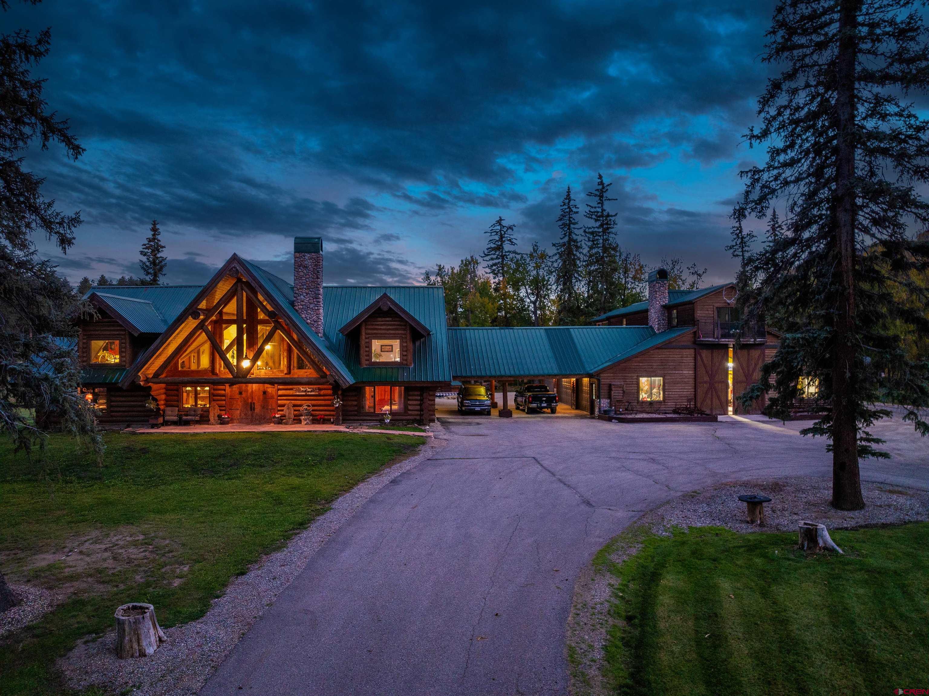 42574 Highway 550 Durango, CO 81301 - Photo 2 of 24 a front view of a house with a yard and garage