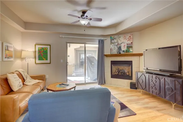 a living room with furniture a fireplace and a flat screen tv