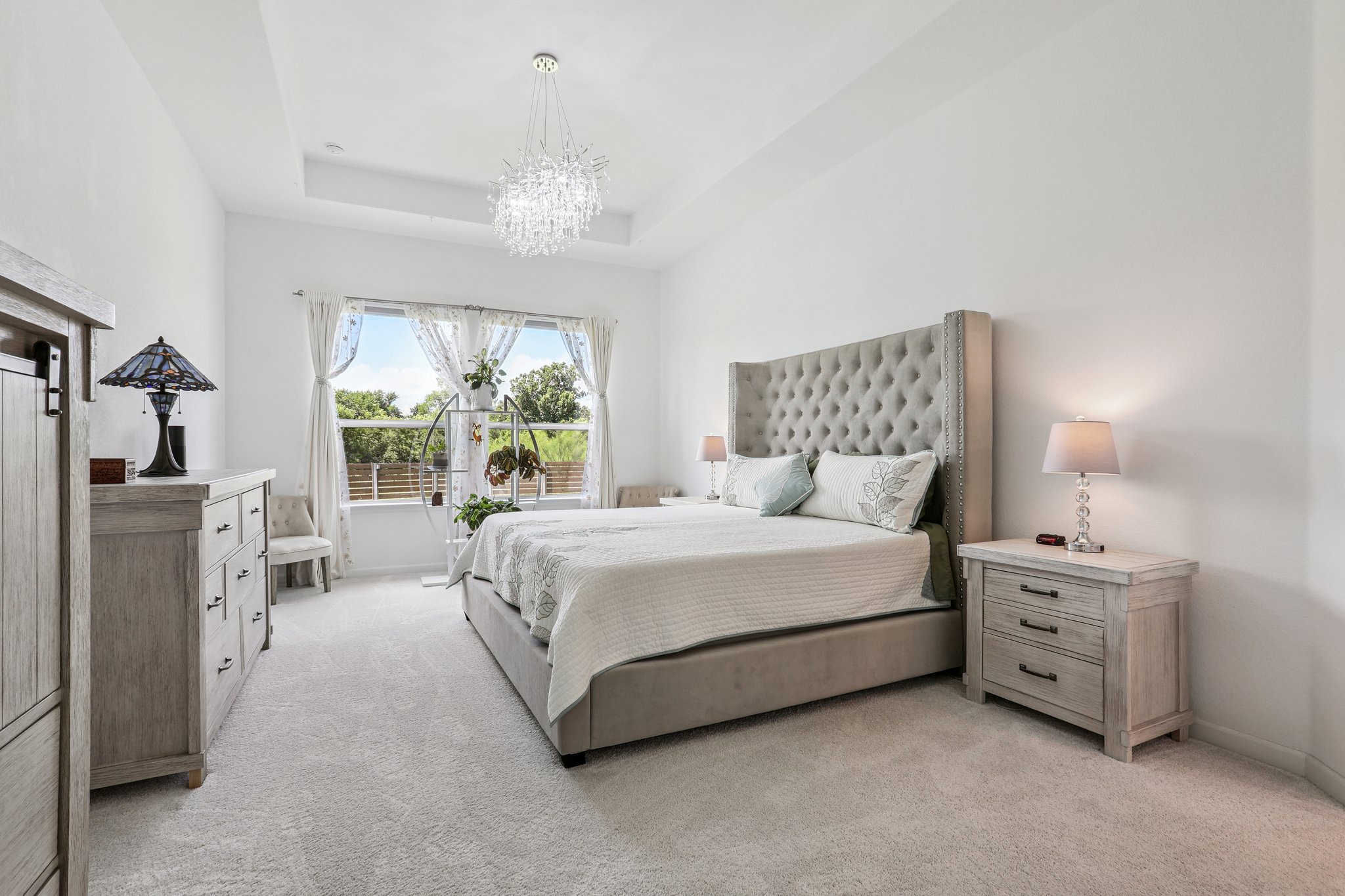 1102 Simmental Loop Hutto, TX 78634 - Photo 11 of 29 a bed room with a bed and a chandelier