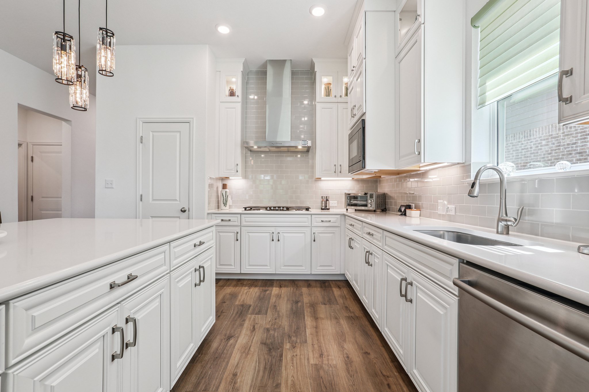 1102 Simmental Loop Hutto, TX 78634 - Photo 8 of 29 a kitchen with granite countertop white cabinets and white appliances
