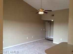 7940 Preserve Circle, Unit 935 Naples, FL 34119 - Photo 3 of 8 a view of an empty room with a chandelier fan