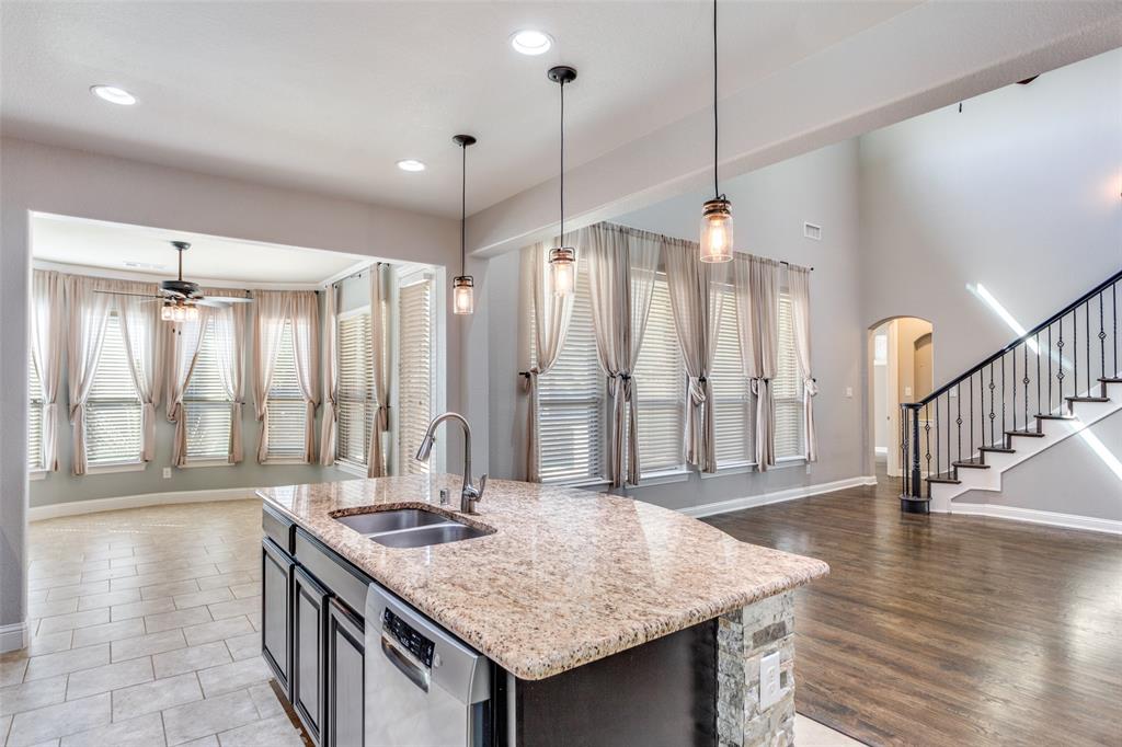 1505 5th Street Argyle, TX 76226 - Photo 12 of 25 a kitchen with stainless steel appliances granite countertop a stove a refrigerator and a sink with wooden floor