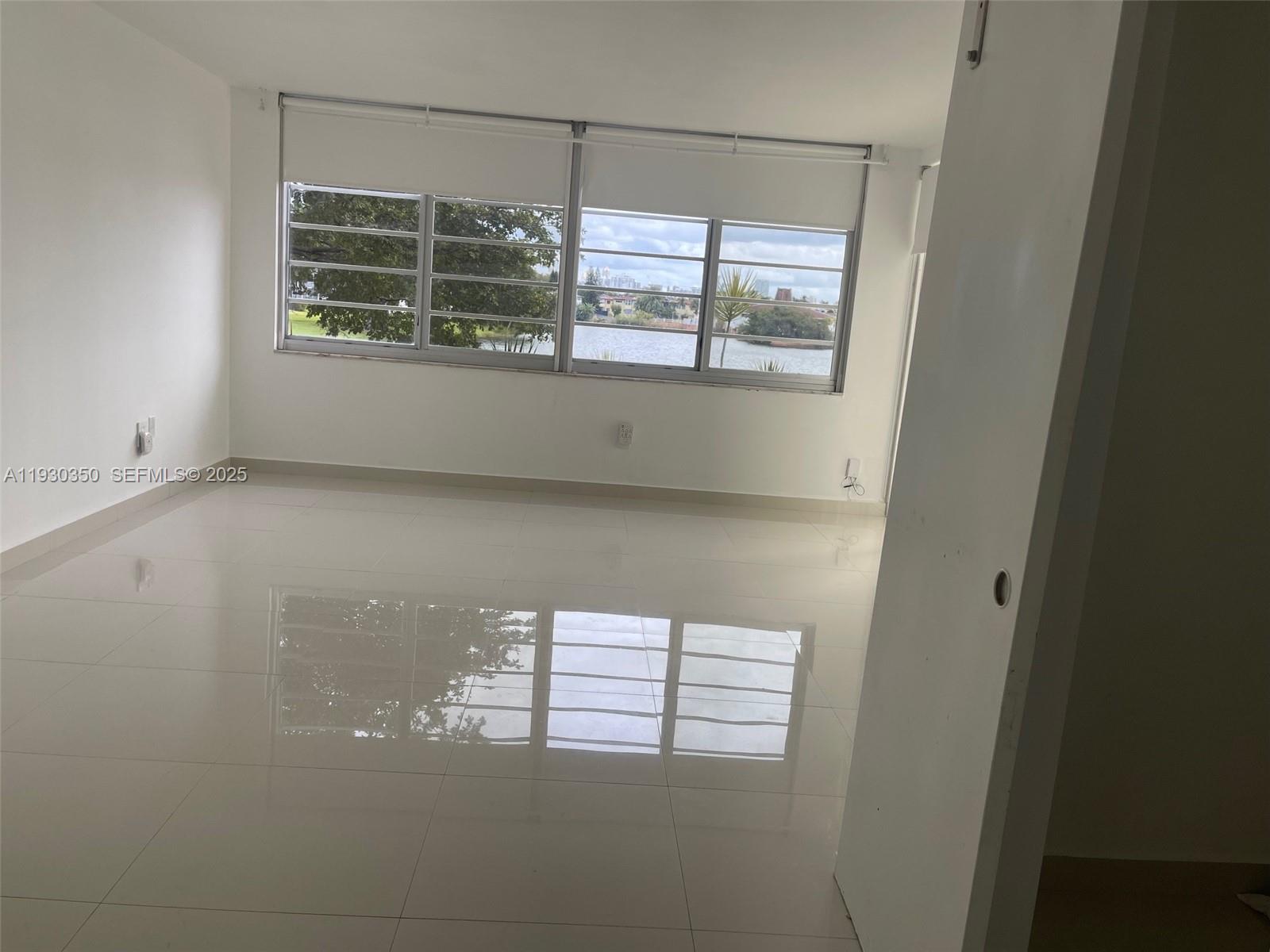 1670 Northeast 191st Street, Unit 2133 Miami, FL 33179 - Photo 6 of 15 a view of an empty room with a window