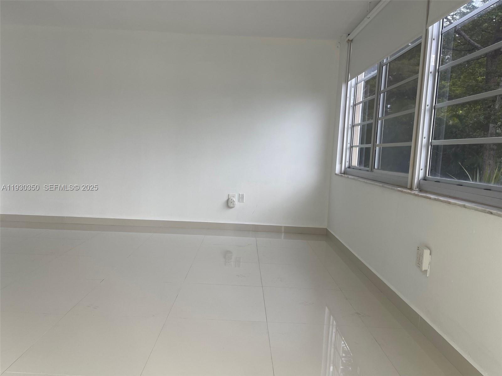 1670 Northeast 191st Street, Unit 2133 Miami, FL 33179 - Photo 7 of 15 a view of an empty room with a window