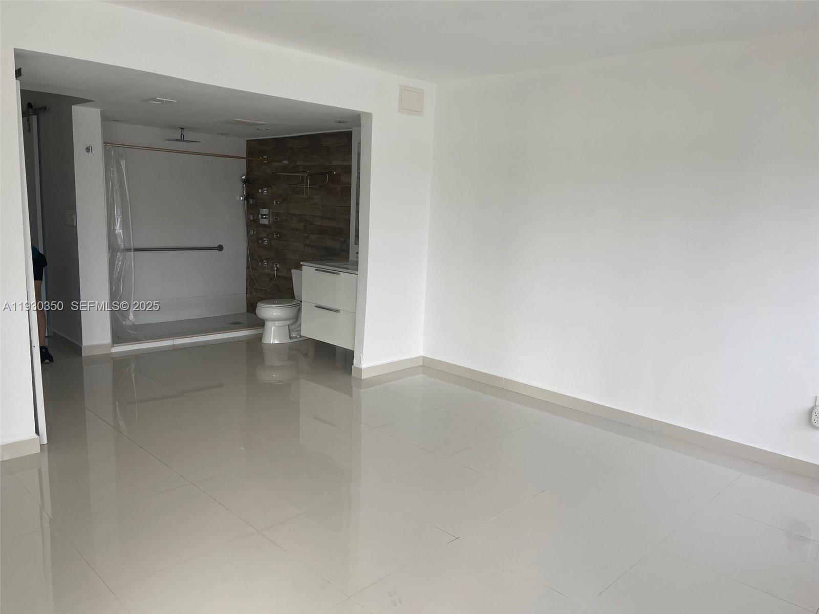 1670 Northeast 191st Street, Unit 2133 Miami, FL 33179 - Photo 8 of 15 a view of an empty room and a window