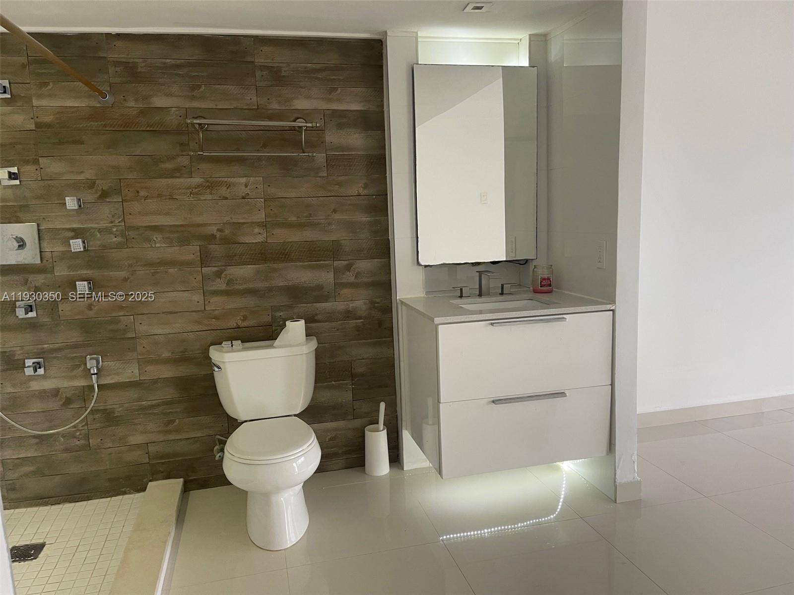 1670 Northeast 191st Street, Unit 2133 Miami, FL 33179 - Photo 9 of 15 a bathroom with a toilet and a sink