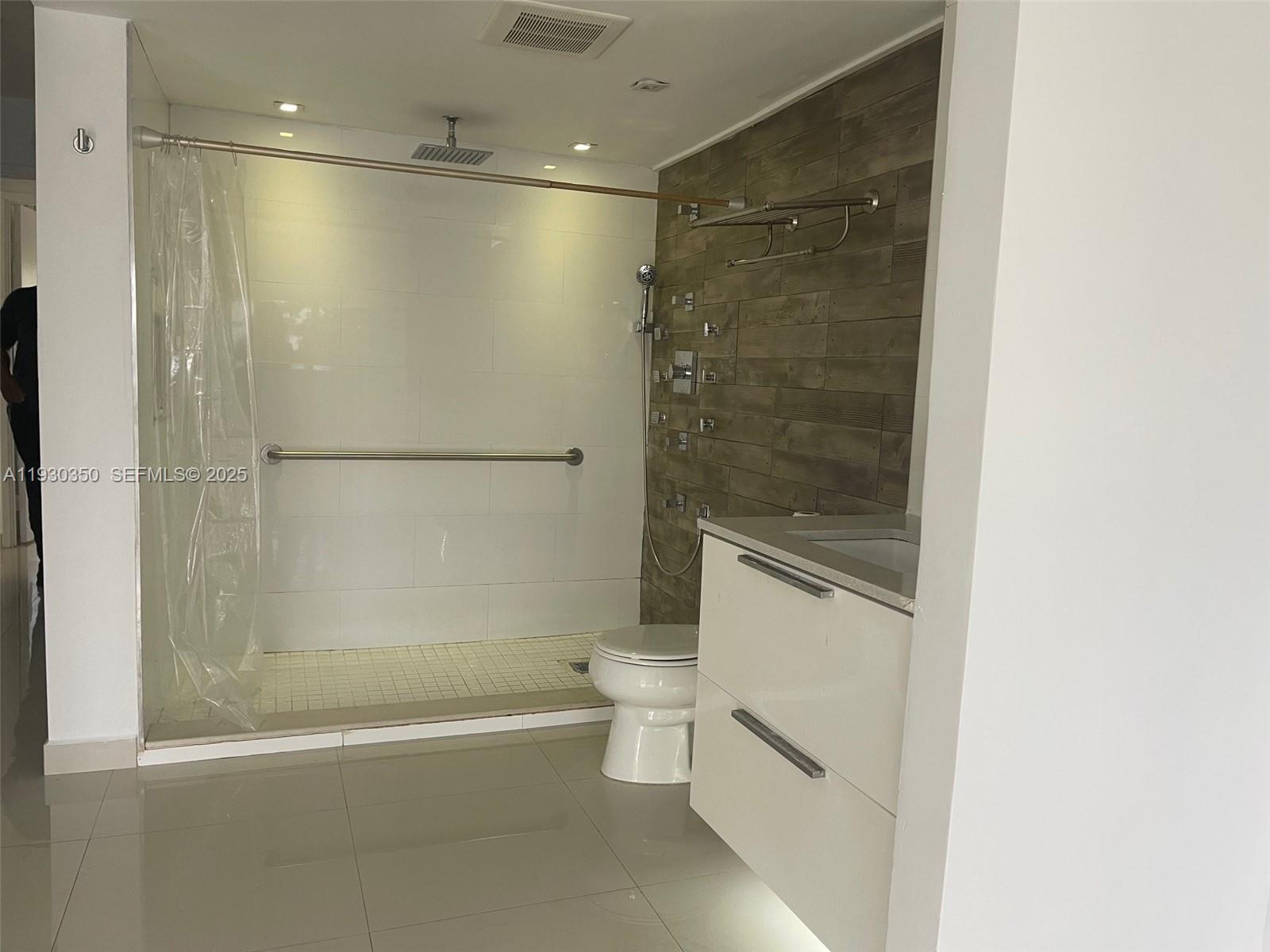 1670 Northeast 191st Street, Unit 2133 Miami, FL 33179 - Photo 10 of 15 a bathroom with a shower and a toilet