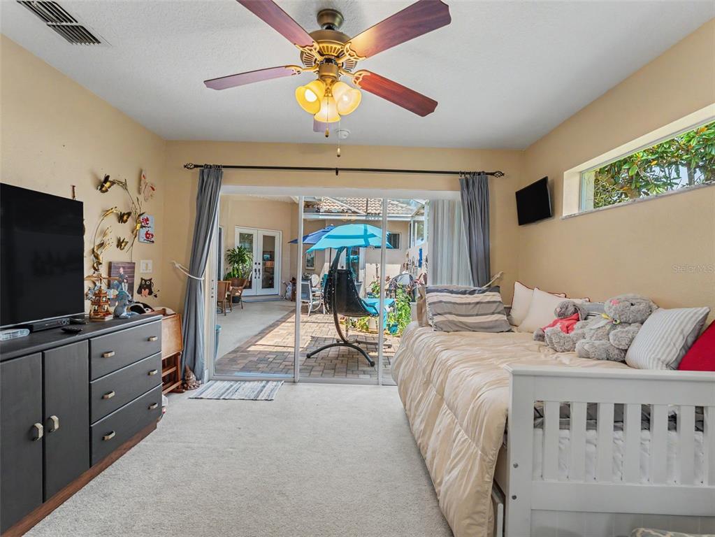 8910 Jericho Road Weeki Wachee, FL 34613 - Photo 8 of 52 a bedroom with furniture and flat screen tv