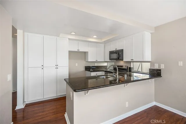 a kitchen with a sink a stove and cabinets