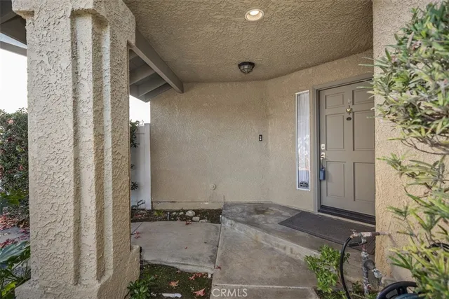 a view of an empty room with wooden floor fireplace and a window