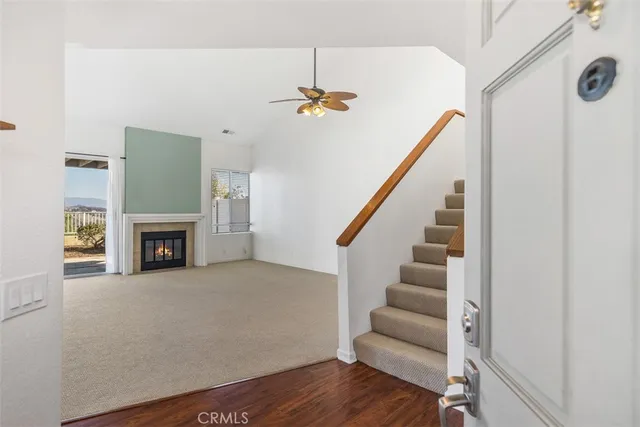 a view of an empty room with a fireplace and a window