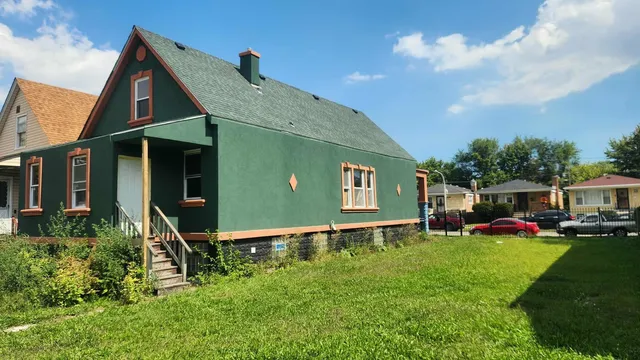 a backyard of a house with table and chairs