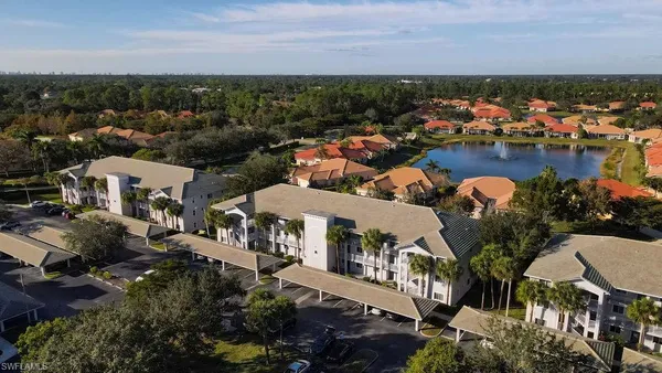 an aerial view of a houses with a lake view