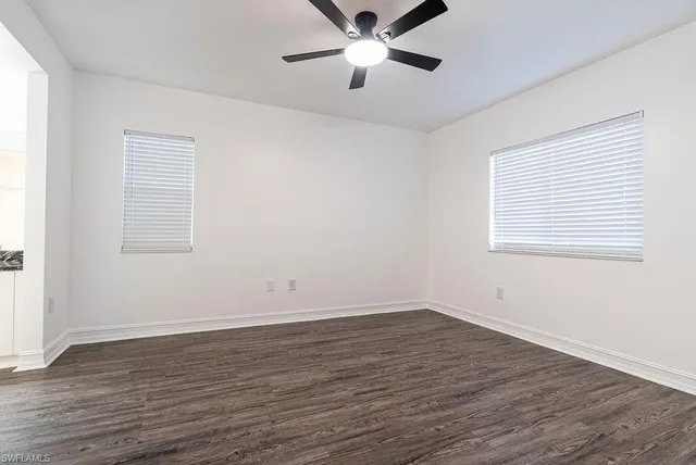 a view of a room with wooden floor and windows
