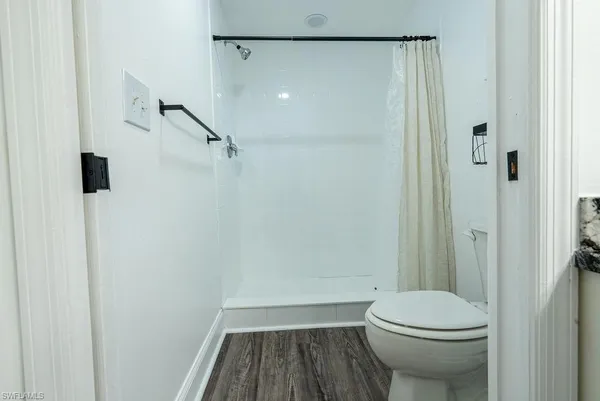 a bathroom with a toilet and a shower