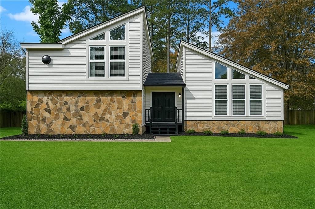 a front view of a house with a yard